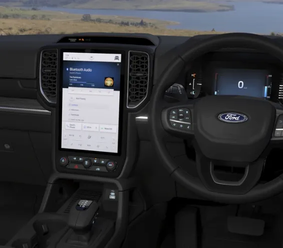 Drivers cockpit with steering wheel, dashboard and infotainement panel 